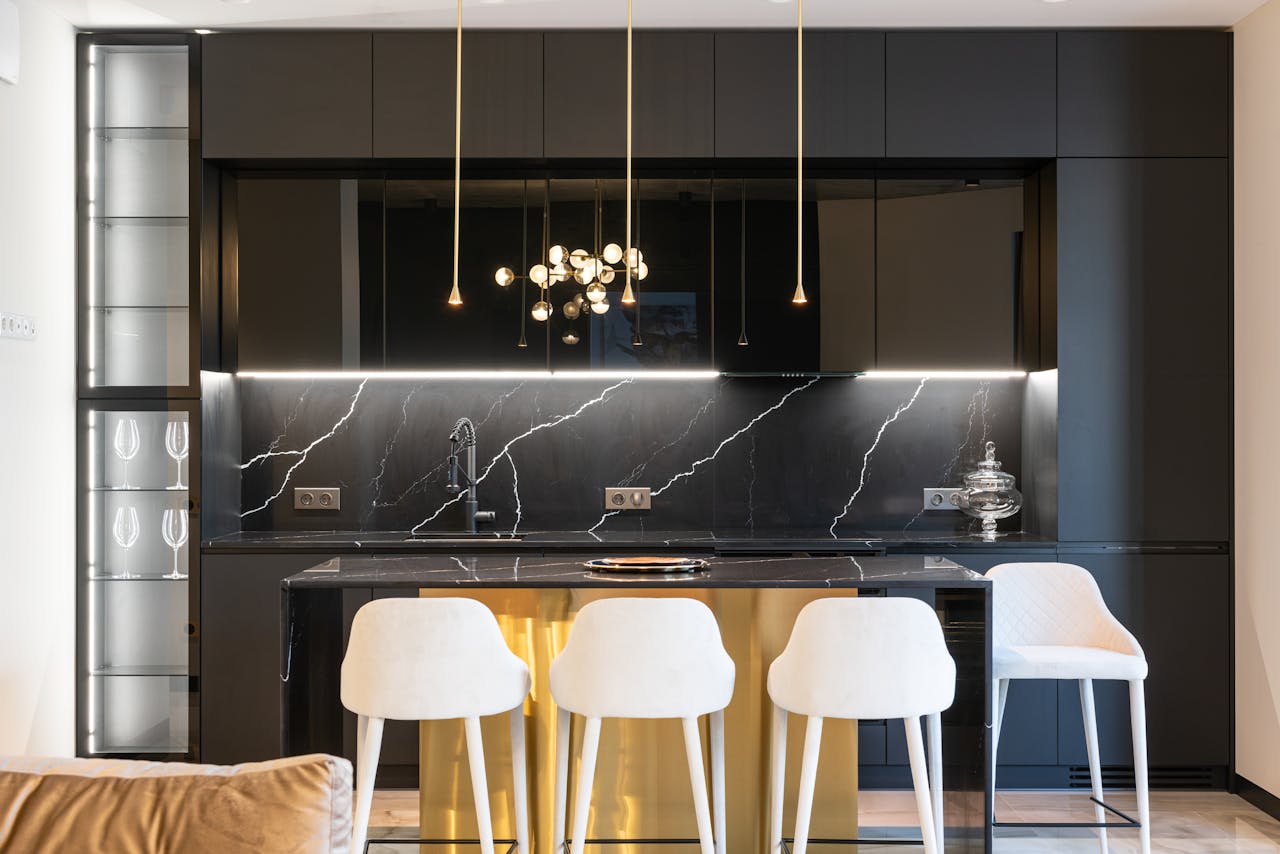 Kitchen interior with counter near chairs and cabinets